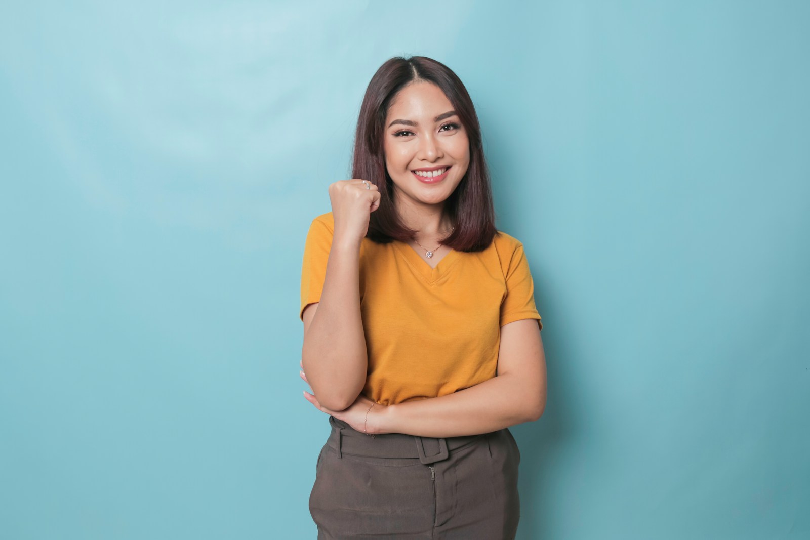 a woman posing for a picture with her arms crossed